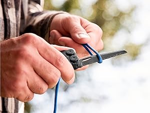 Photo of person cutting rope with a serrated knife on the with the Wave+ multi-tool