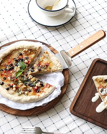 a pizza with a slice missing on a wooden board.