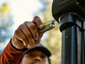 Photo shows person using the Leatherman Bond to make a repair