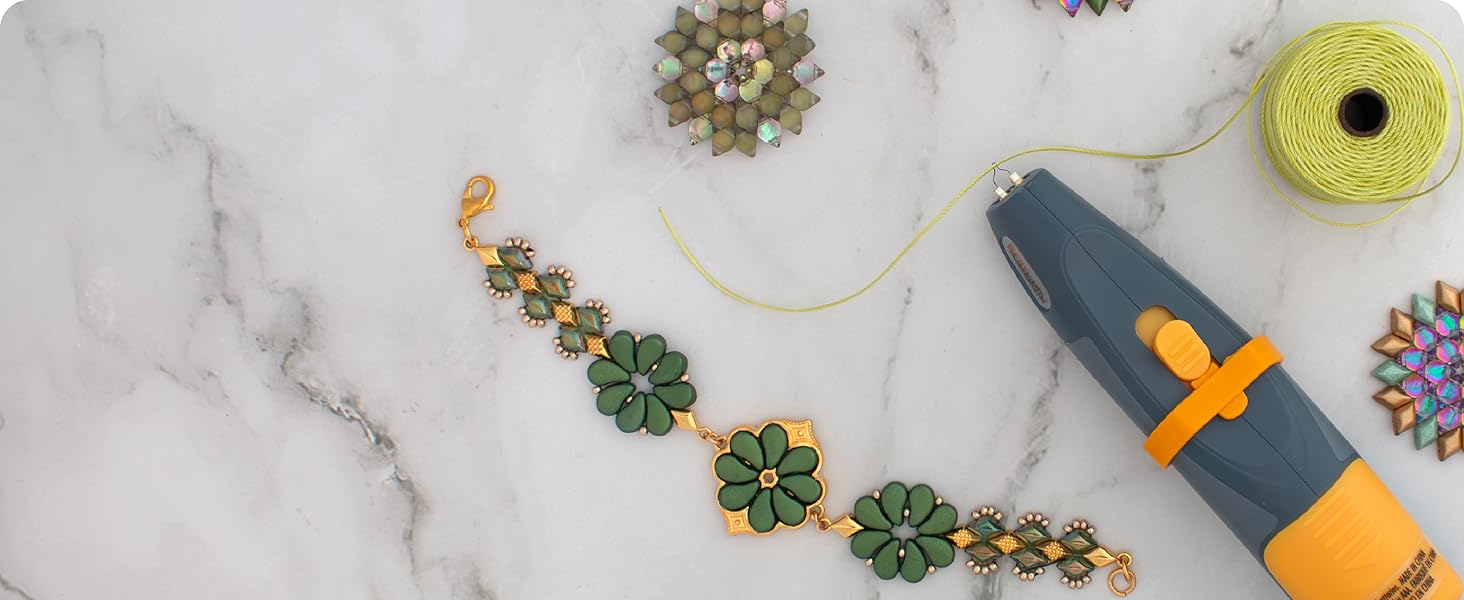 Thread zap ultra on marble table with green s-lon bead cord and green and gold bracelet